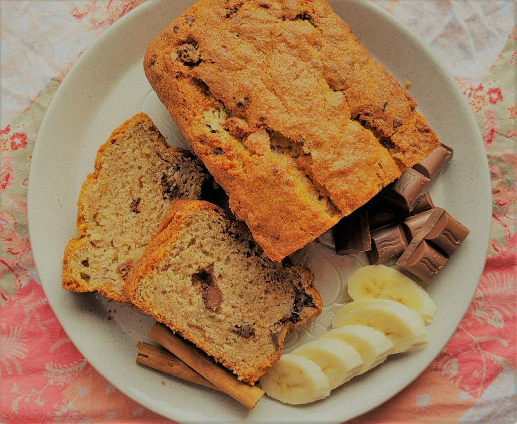A picture of banana chocolate loaf cake with two slices cut.